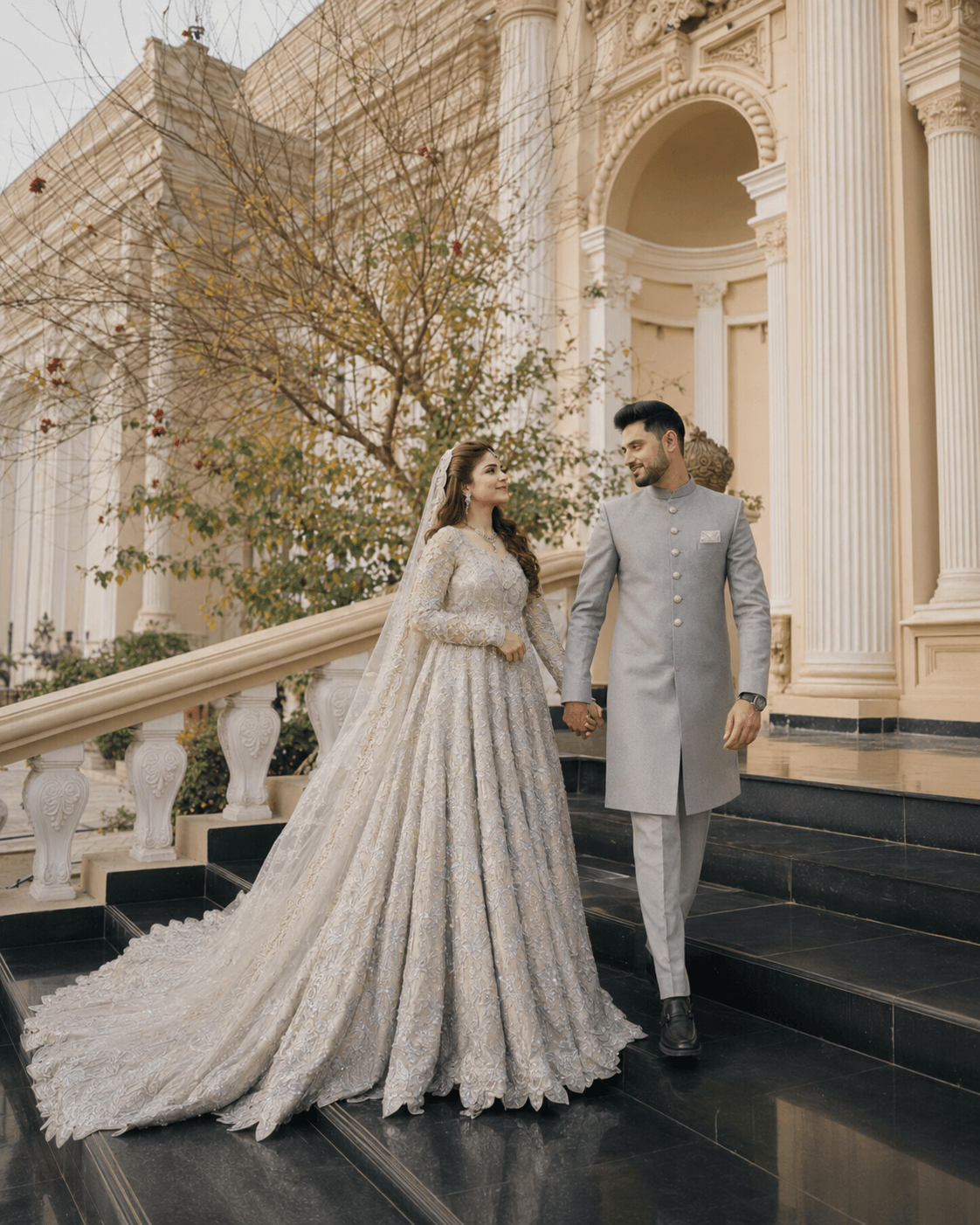 Couple Story Couple walking on palace stairs in silver outfits